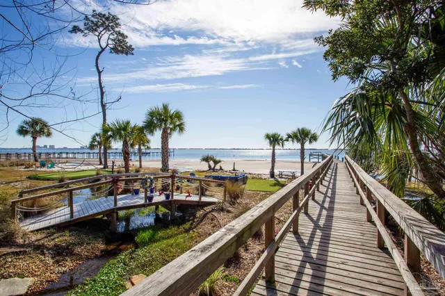 a view of swimming pool with outdoor seating and plants