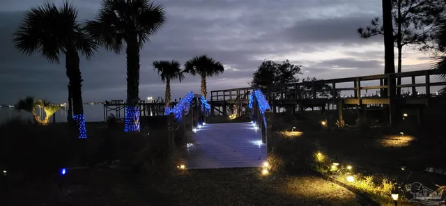 a view of a lobby of a house and floor to ceiling window and tree in the background
