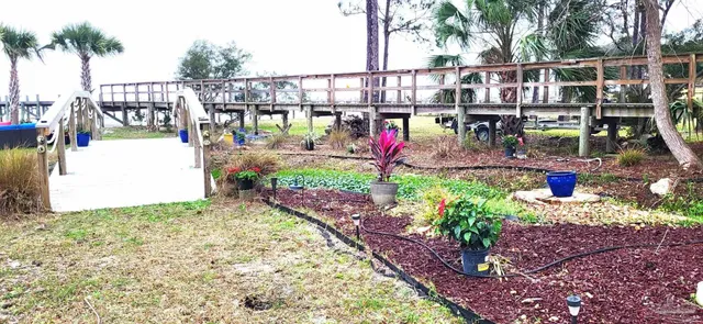 a view of a balcony with chairs and potted plants