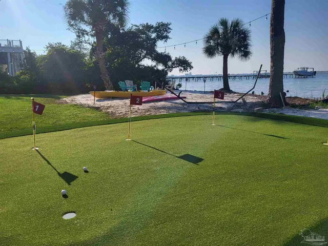 a view of a swimming pool and lounge chairs