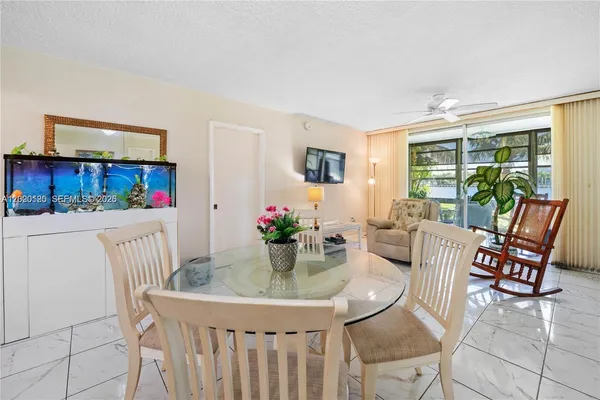 a dining room with furniture and a potted plant