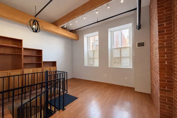 a view of room with window and wooden floor
