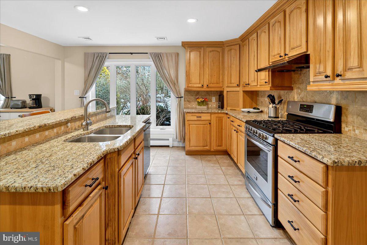 14 Baldwin Street Pennington, NJ 08534 - Photo 11 of 42 a kitchen with granite countertop a sink a counter top space appliances and cabinets