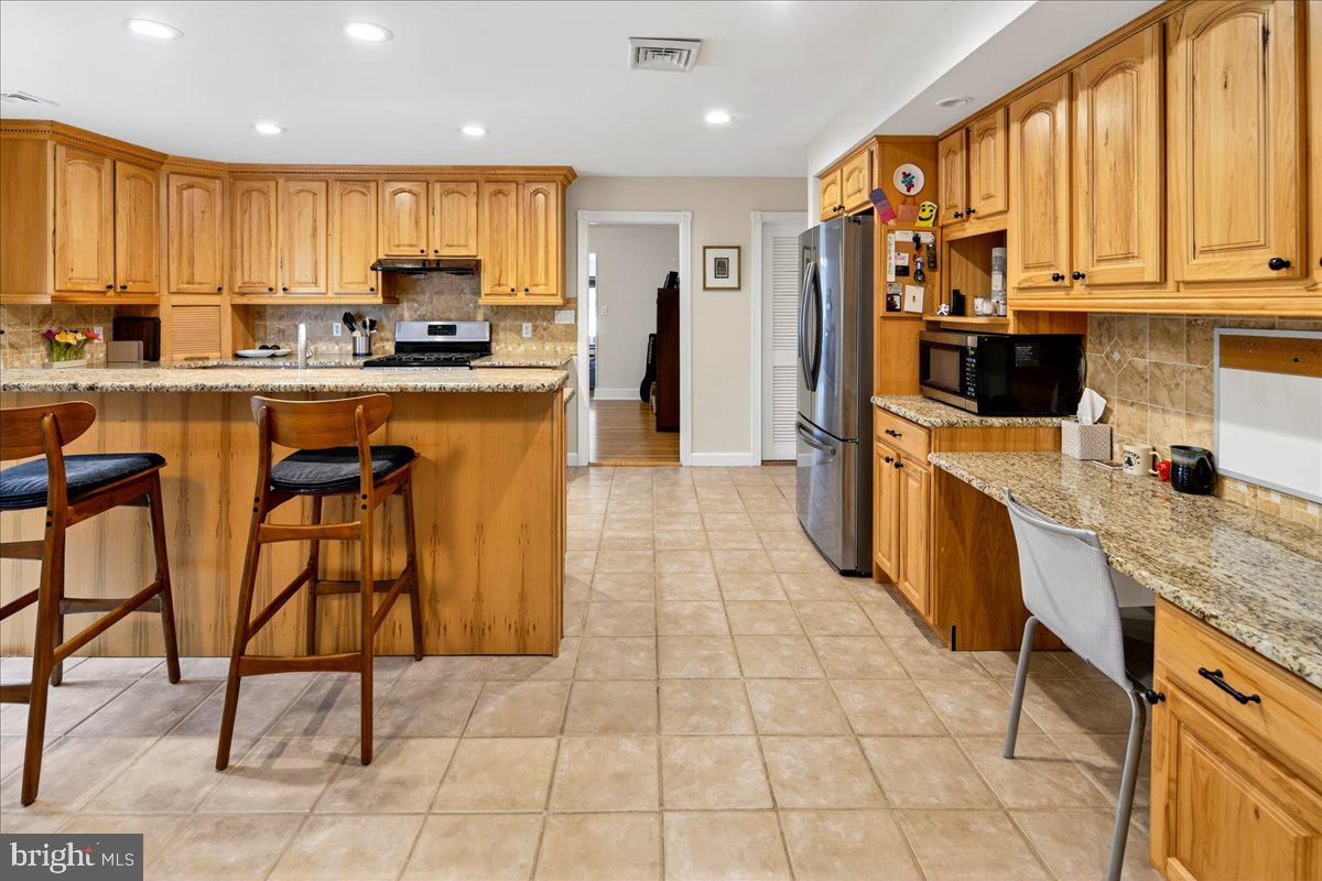 14 Baldwin Street Pennington, NJ 08534 - Photo 13 of 42 a kitchen with stainless steel appliances granite countertop a stove a sink and a refrigerator