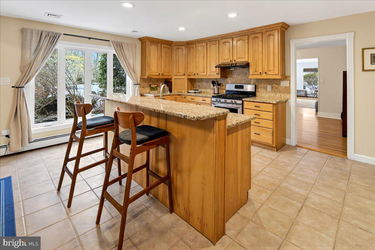 14 Baldwin Street Pennington, NJ 08534 - Photo 14 of 42 a kitchen with stainless steel appliances granite countertop a stove top oven a refrigerator a sink and a granite counter tops
