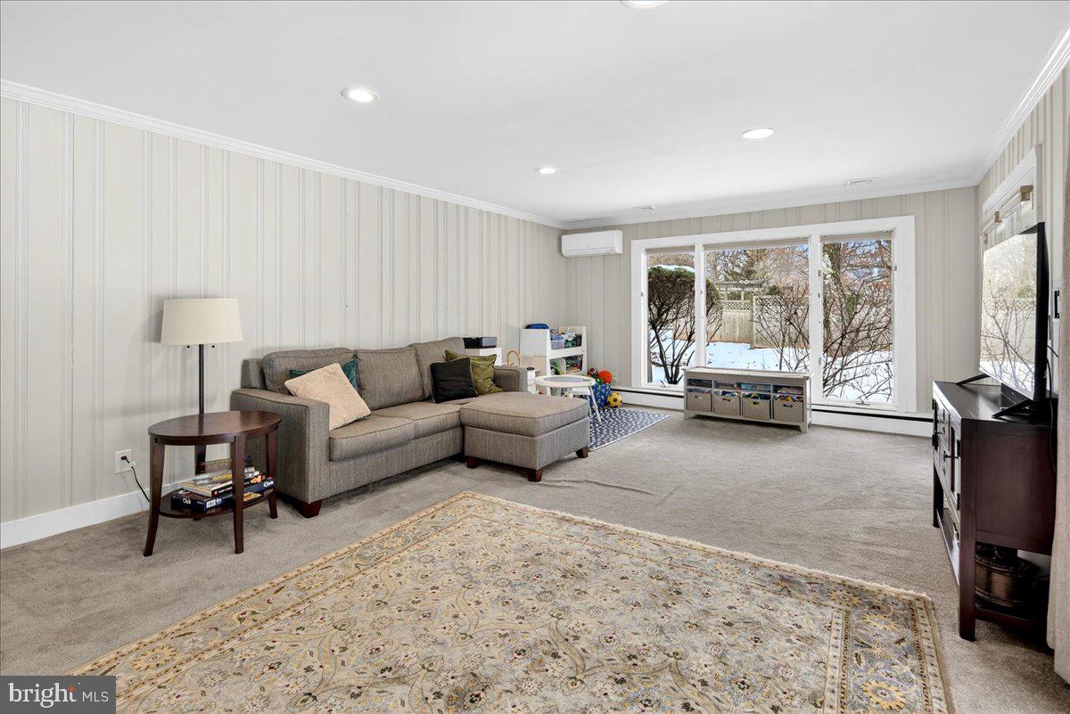14 Baldwin Street Pennington, NJ 08534 - Photo 20 of 42 a living room with furniture a large window and a flat screen tv