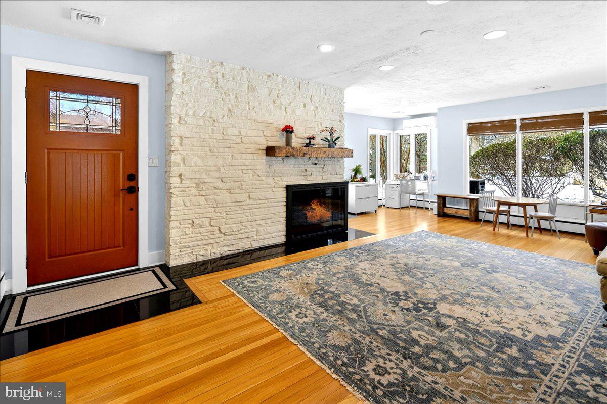 14 Baldwin Street Pennington, NJ 08534 - Photo 2 of 42 a living room with furniture flat screen tv and a fireplace