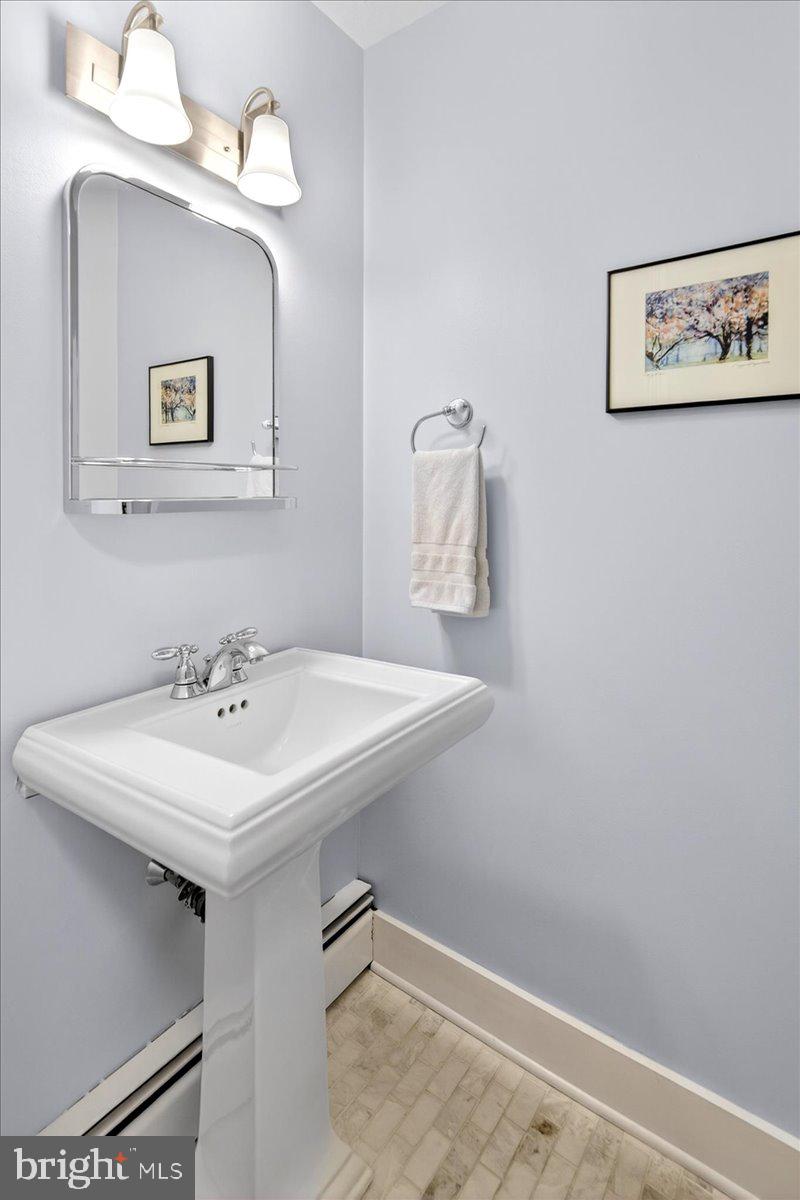 14 Baldwin Street Pennington, NJ 08534 - Photo 22 of 42 a bathroom with a sink a mirror and a lamp