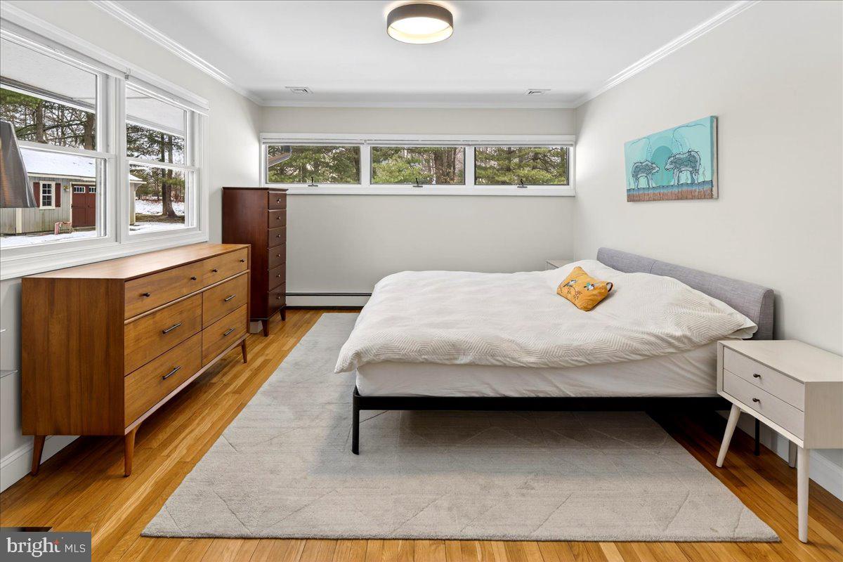 14 Baldwin Street Pennington, NJ 08534 - Photo 25 of 42 a bedroom with a bed and wooden floor