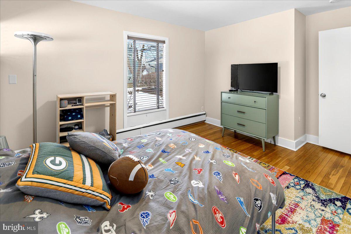 14 Baldwin Street Pennington, NJ 08534 - Photo 30 of 42 a bedroom with a bed and flat screen tv