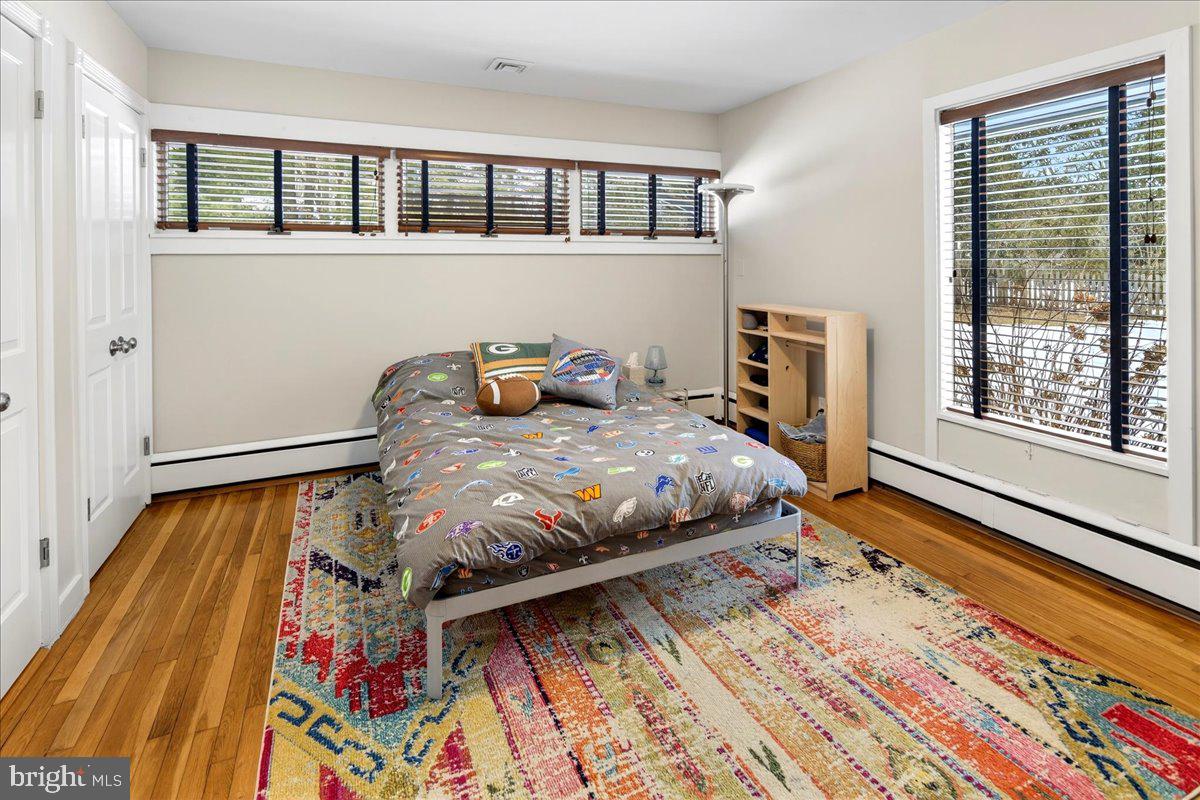 14 Baldwin Street Pennington, NJ 08534 - Photo 32 of 42 a bedroom with a bed and wooden floor