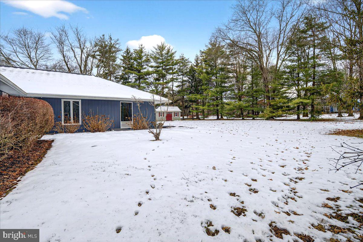 14 Baldwin Street Pennington, NJ 08534 - Photo 39 of 42 a view of white house with a yard covered in snow