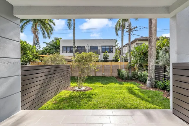 a view of house with backyard outdoor seating and hardwood