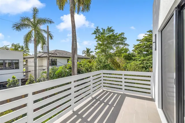 a view of a balcony with lake view and a palm space