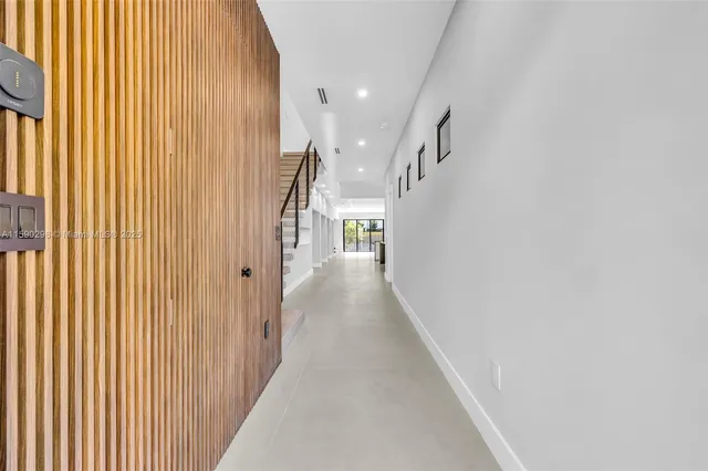 a view of a hallway with wooden floor and entryway