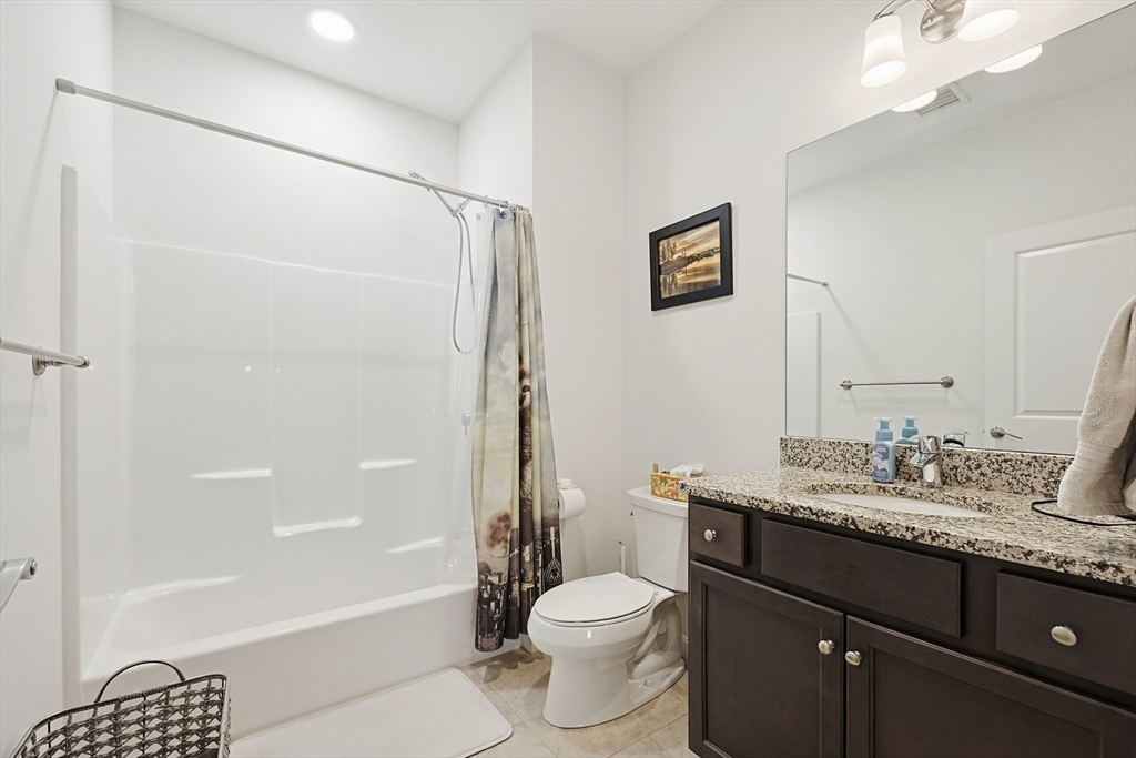 200 Revere Street, Unit 4209 Canton, MA 02021 - Photo 26 of 35 a bathroom with a granite countertop sink toilet and shower