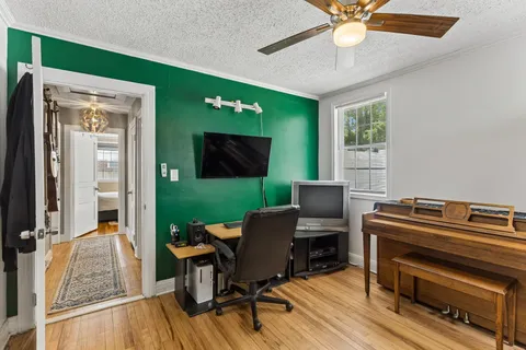 a view of a workspace with furniture and a window