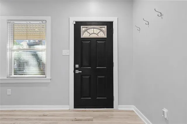 a view of a livingroom with wooden floor and a fireplace