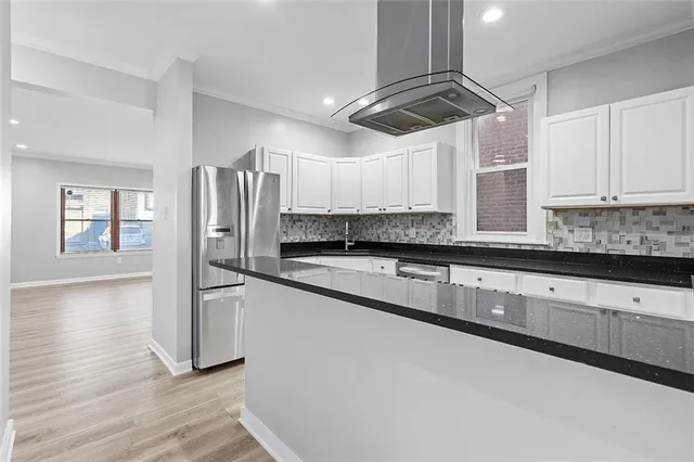 a kitchen with stainless steel appliances granite countertop a sink a stove and a granite counter tops