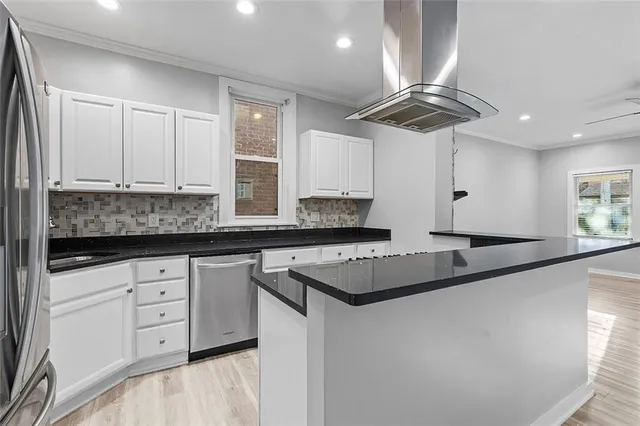 a kitchen with granite countertop white cabinets and sink