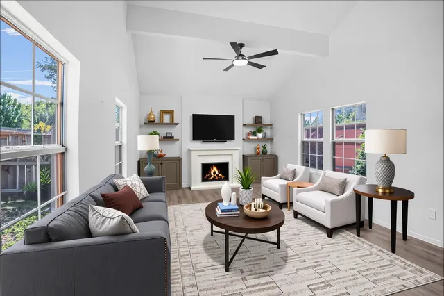 a living room with furniture a fireplace and a flat screen tv
