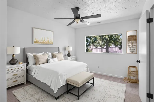 a bedroom with a bed and a window