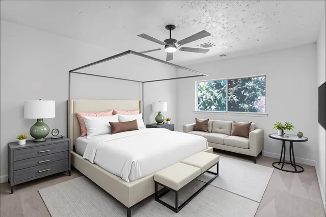 a bedroom with a bed and ceiling fan