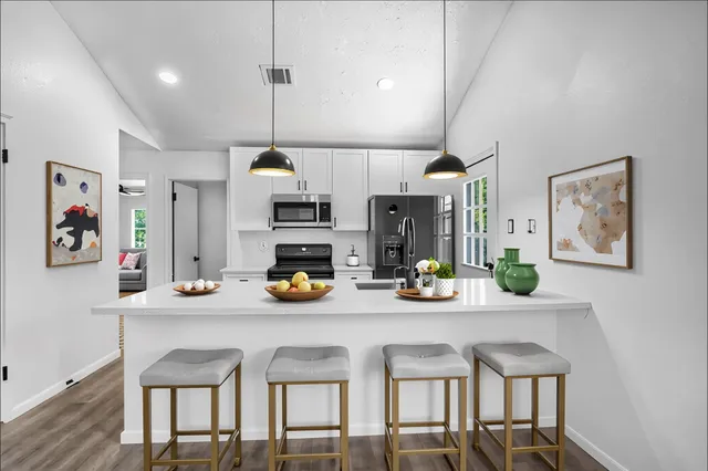 a kitchen with a sink cabinets and dining table