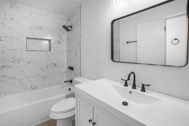 a bathroom with a sink toilet and shower