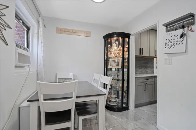 a dining room with a furniture and a refrigerator