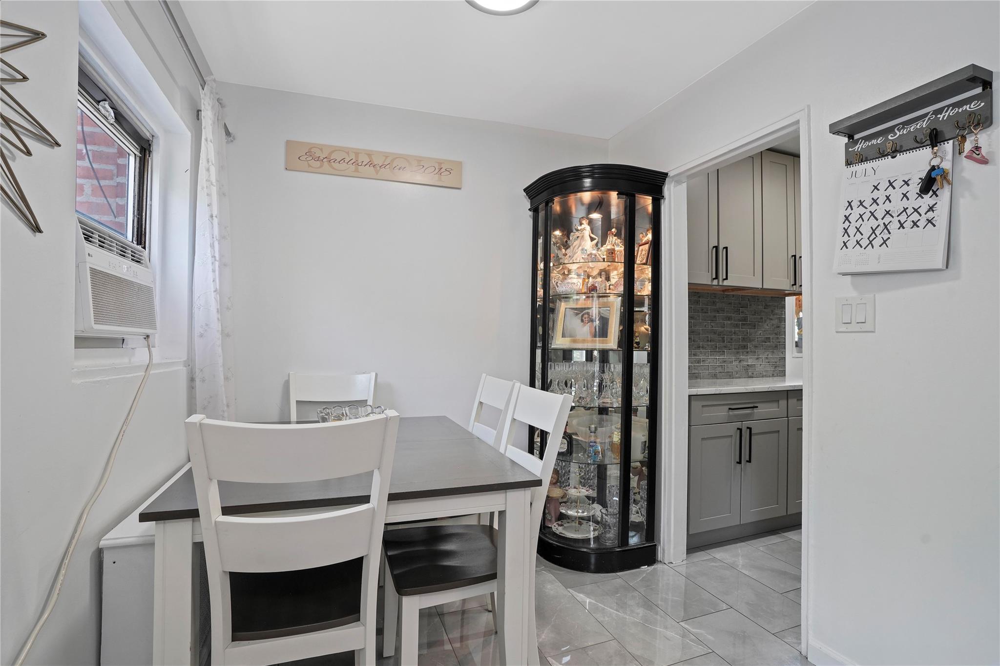 1001 Shore Parkway, Unit 2B Brooklyn, NY 11228 - Photo 11 of 23 a dining room with a furniture and a refrigerator