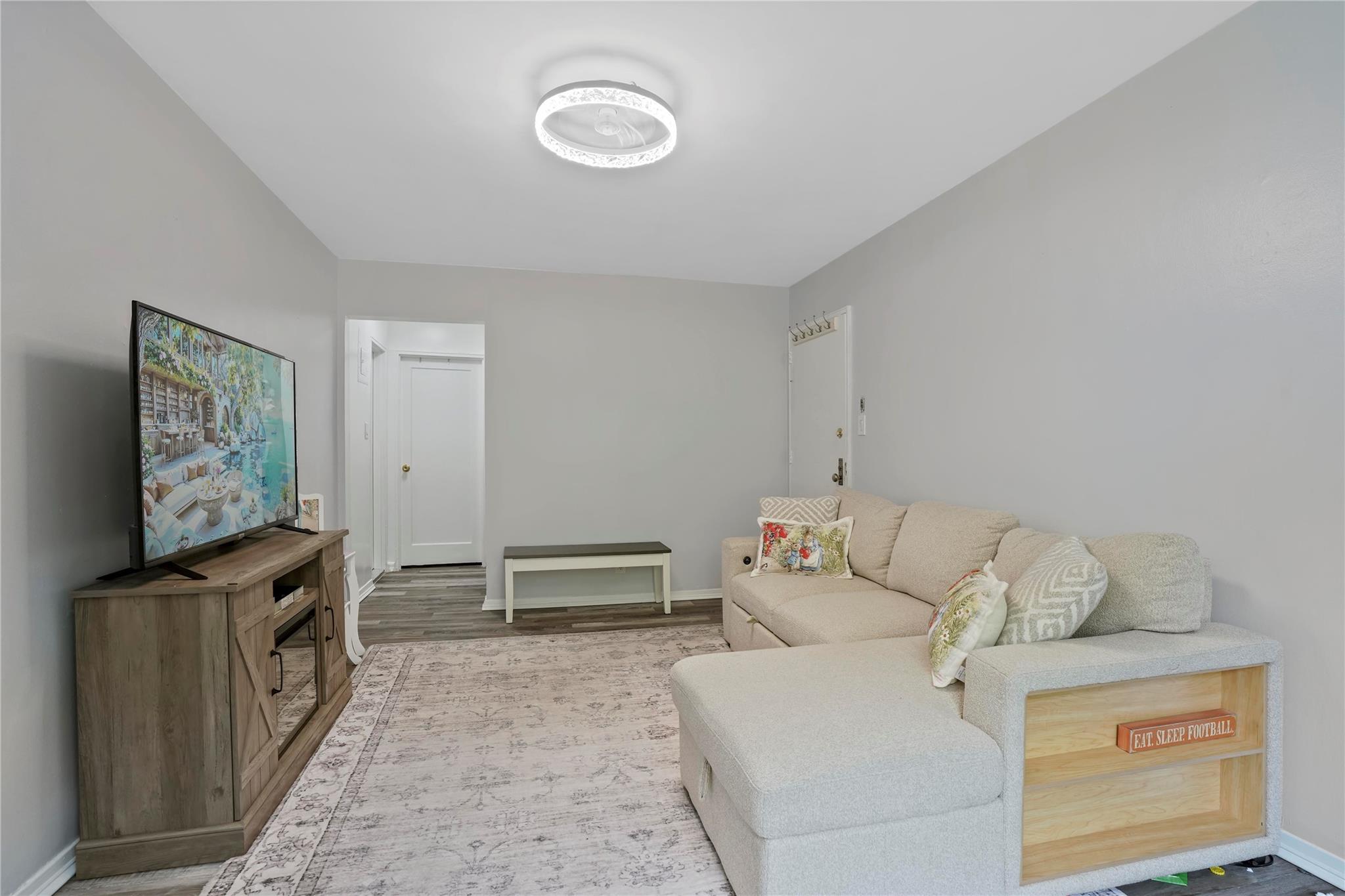 1001 Shore Parkway, Unit 2B Brooklyn, NY 11228 - Photo 4 of 23 a living room with furniture and a flat screen tv