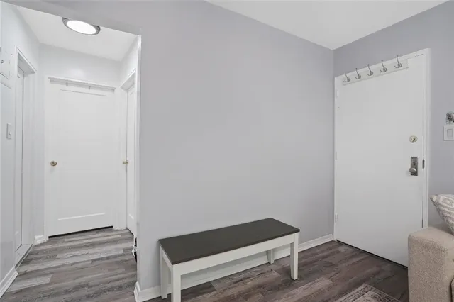 a room with a bench and a wooden floor