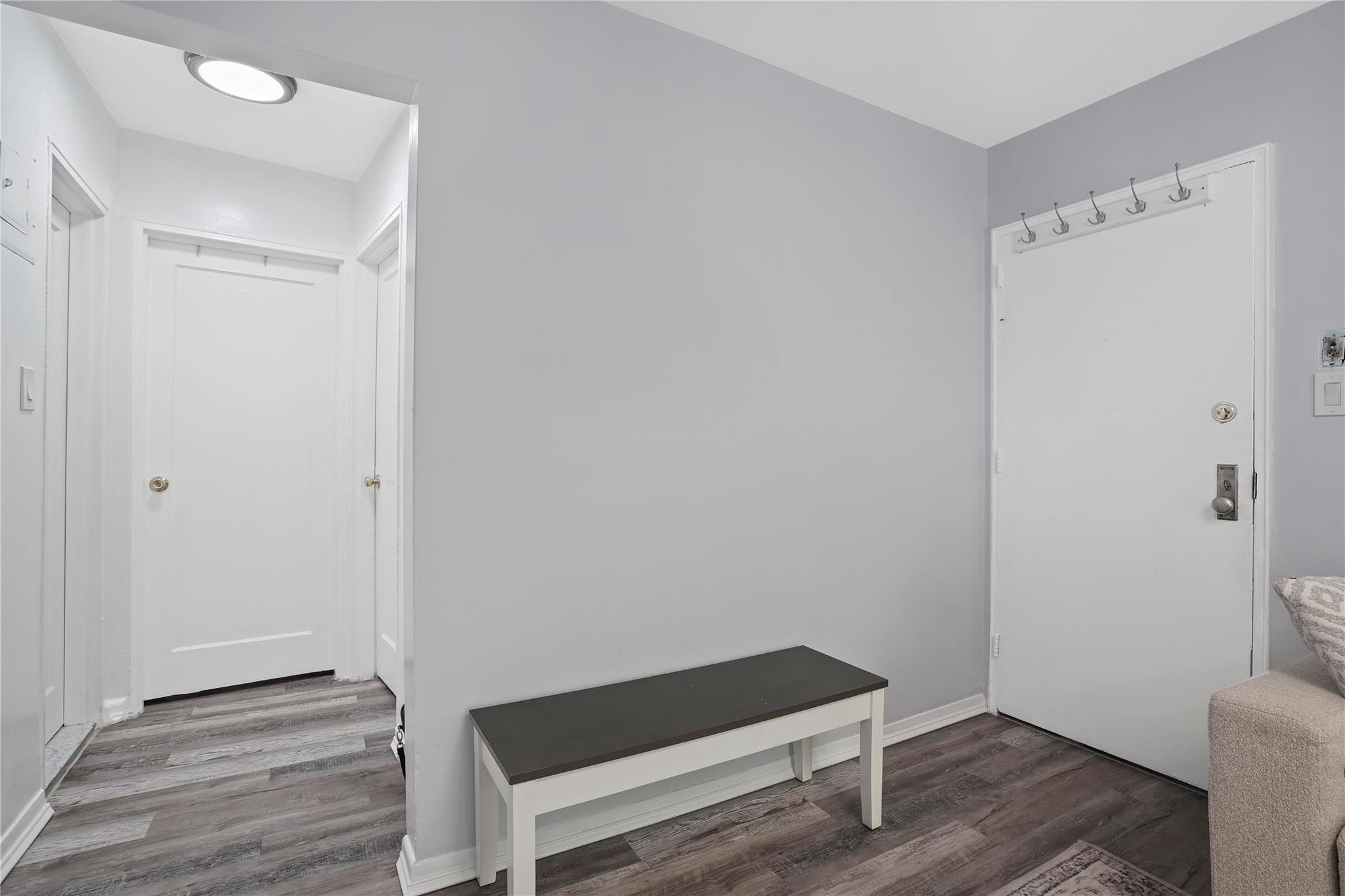 1001 Shore Parkway, Unit 2B Brooklyn, NY 11228 - Photo 5 of 23 a room with a bench and a wooden floor