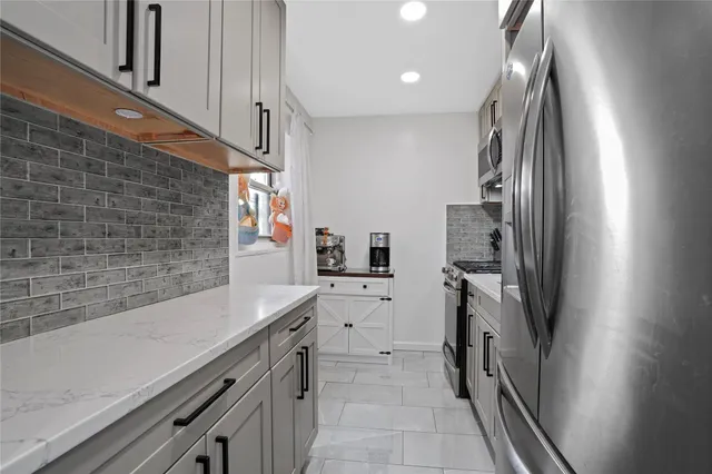 a kitchen with a sink cabinets and stainless steel appliances