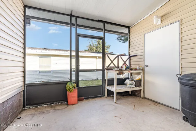 a bedroom with furniture and large windows