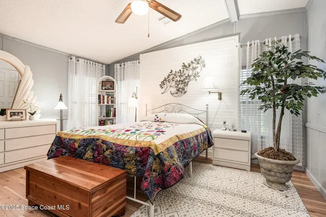 a bedroom with bed and a potted plant