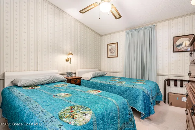 a bedroom with 2 bed and a window