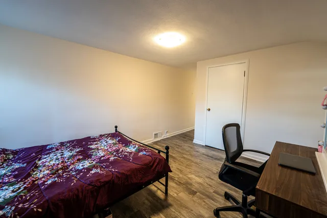 a living room with furniture a flat screen tv and a table