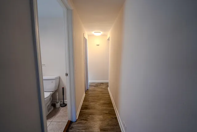 a white toilet sitting next to a bath tub