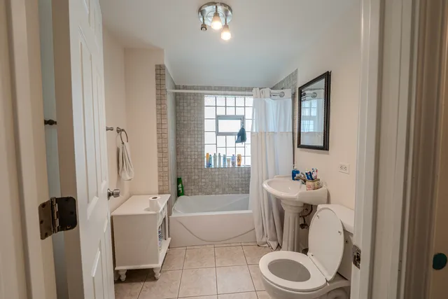 a aerial view of a house with swimming pool and large trees