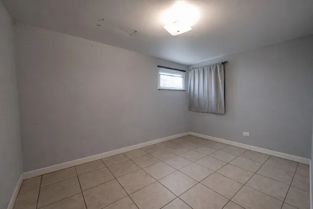 a aerial view of a house with swimming pool and large trees