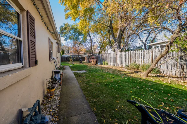 a view of a chair and table in backyard
