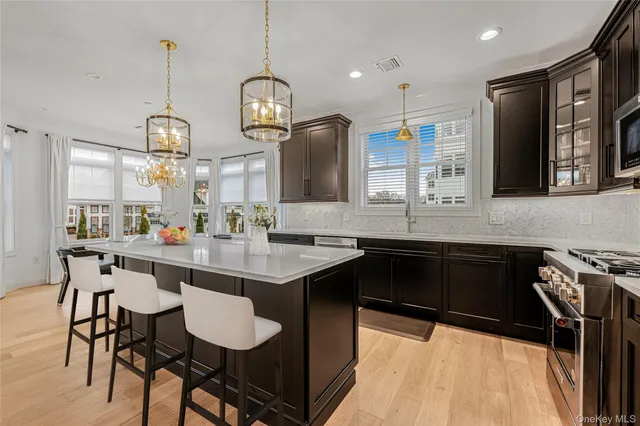 a kitchen with stainless steel appliances a sink stove and refrigerator