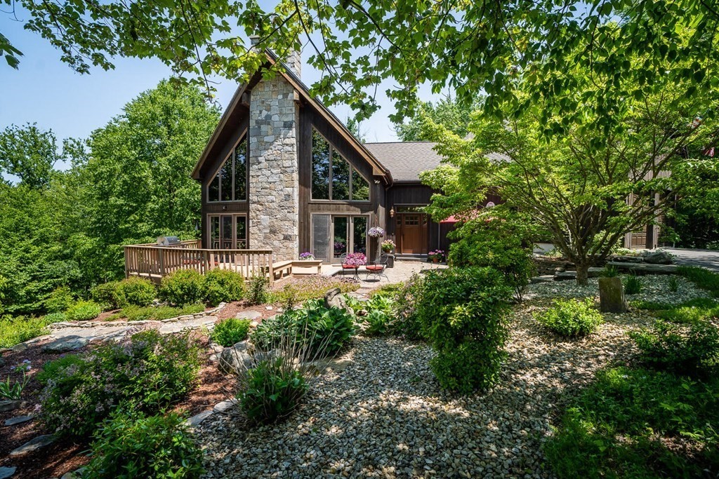 a front view of a house with yard and green space