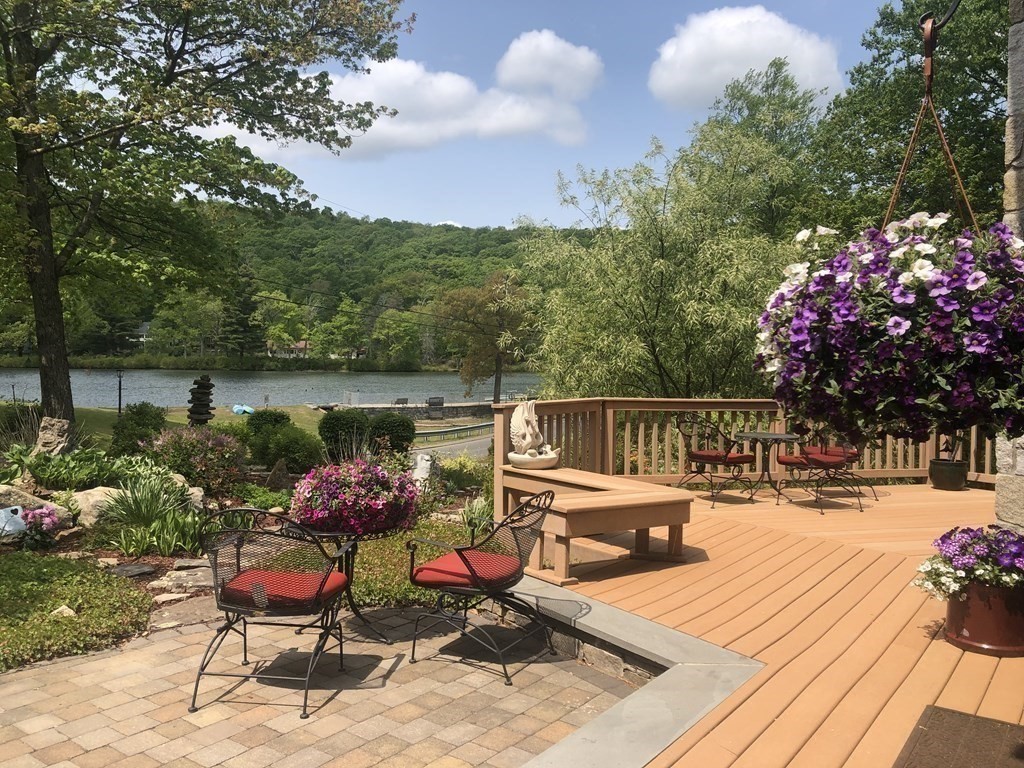 73 Paradise Lake Road Monson, MA 01057 - Photo 2 of 30 a view of a chairs and tables on the deck