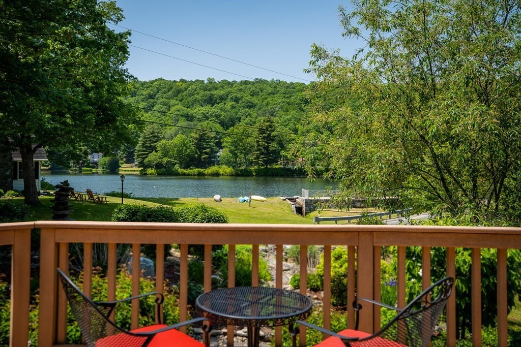 73 Paradise Lake Road Monson, MA 01057 - Photo 8 of 30 a view of a wooden deck with a lake view