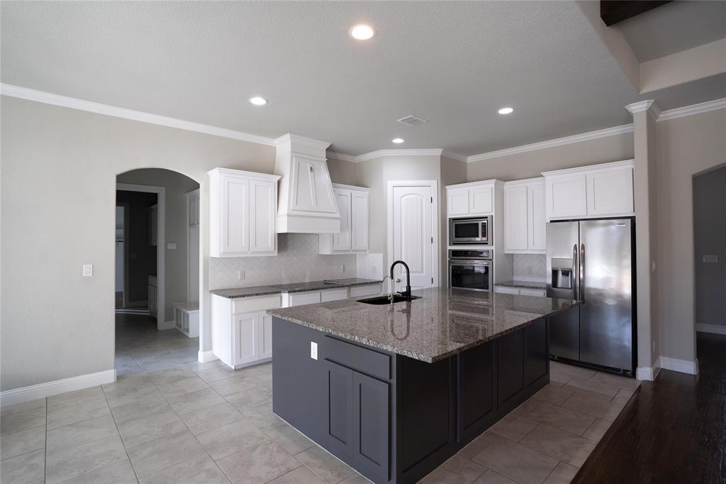 181 Fairview Court Decatur, TX 76234 - Photo 12 of 35 a kitchen with stainless steel appliances granite countertop a refrigerator and a sink