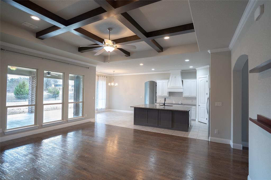 181 Fairview Court Decatur, TX 76234 - Photo 15 of 35 a view of a big room with wooden floor windows and a kitchen