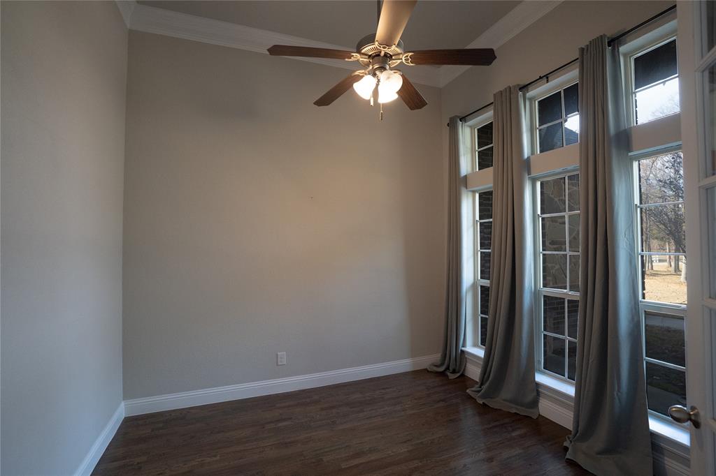 181 Fairview Court Decatur, TX 76234 - Photo 16 of 35 an empty room with wooden floor and a ceiling fan